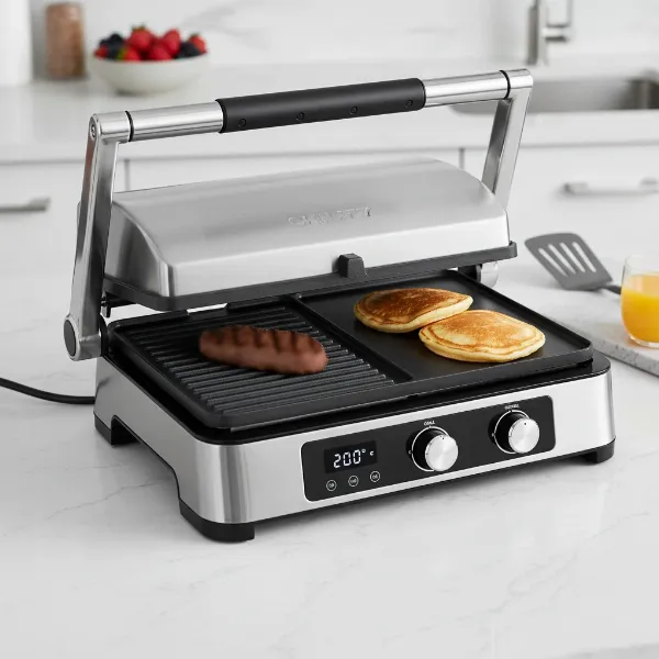 A modern, versatile electric contact grill open flat, showcasing ribbed and griddle plates for multi-functional cooking.